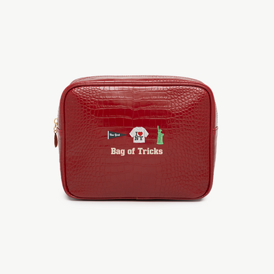 Red textured pouch with 'Bag of Tricks' text and logo on a white background