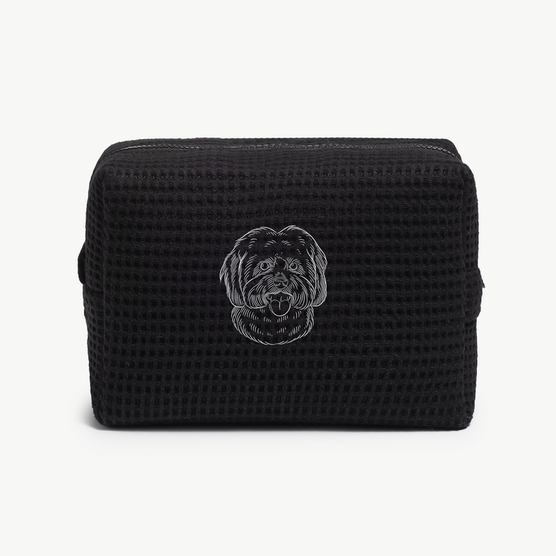 A black waffle zippered pouch with a white line drawing of a dogs face on the front.