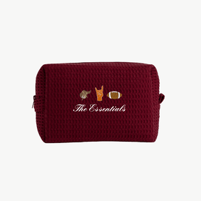 maroon waffle pouch with embroidered icons and text