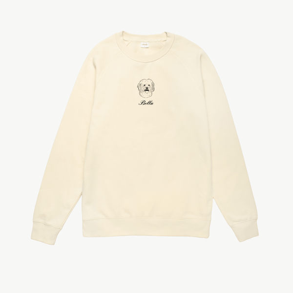 Cream sweatshirt with a dog illustration and 'Bella' text on a white background