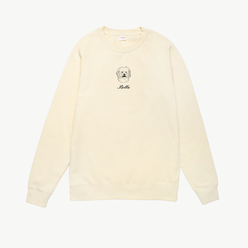 Cream sweatshirt with a dog illustration and 'Bella' text on a white background