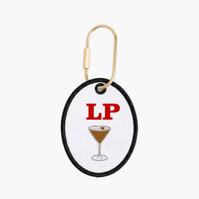 Keychain with a cocktail illustration and 'LP' text on a white background