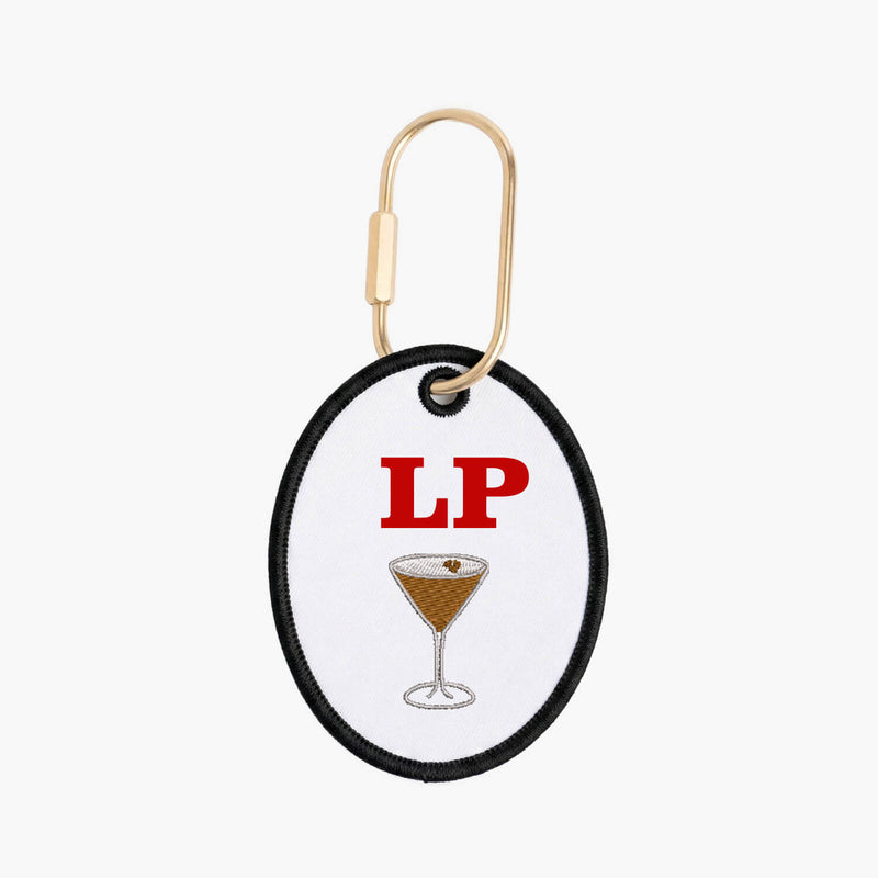 Keychain with a cocktail illustration and 'LP' text on a white background