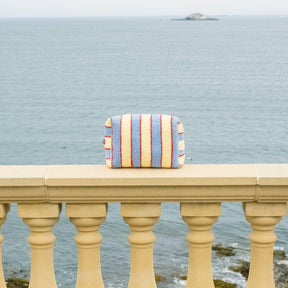 Striped bag on a railing with ocean view