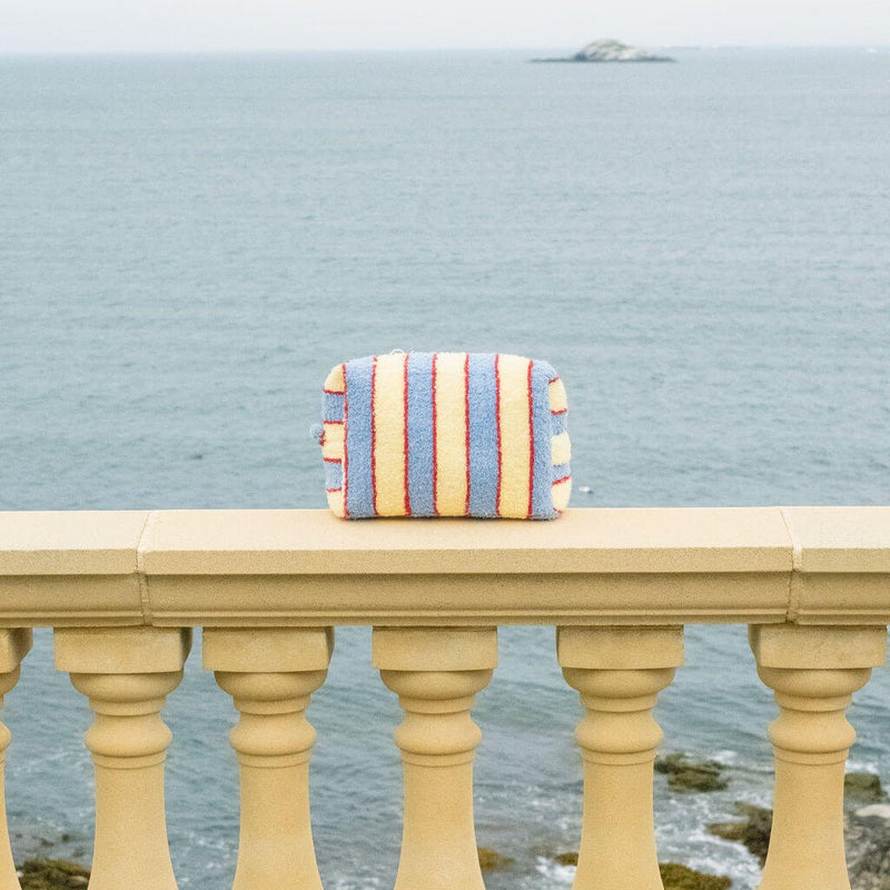 Striped bag on a railing with ocean view