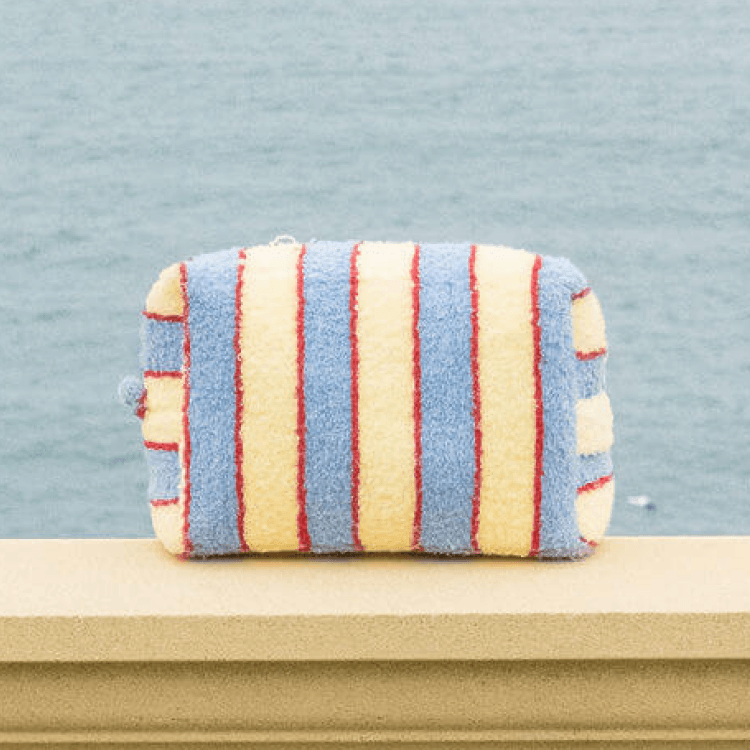 Striped pouch with red, yellow, and blue stripes on a light blue background
