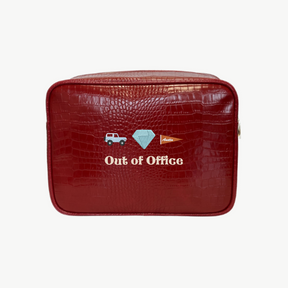 Red crocodile-textured pouch with 'Out of Office' text and icons on a white background