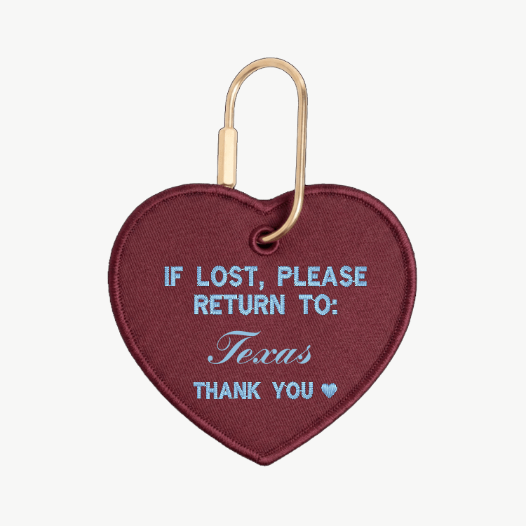 Heart-shaped keychain with text 'If lost, please return to: Texas' on a white background

