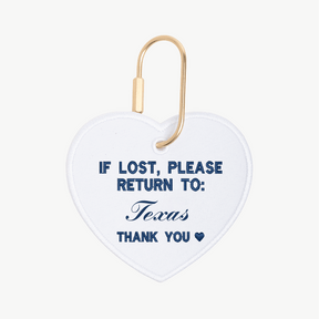 Heart-shaped tag with 'If lost, please return to: Texas' text on a white background