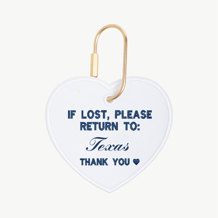 Heart-shaped tag with 'If lost, please return to: Texas' text on a white background