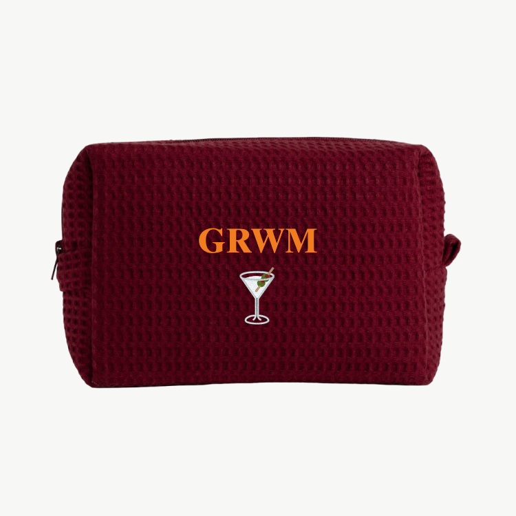 Maroon pouch with 'GRWM' and a martini glass design on a white background