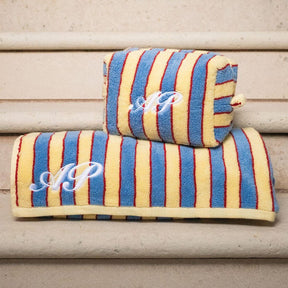 Two striped towels with monogram on a wooden surface