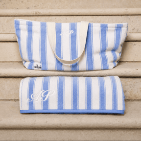 Blue and white striped bag and towel on wooden steps