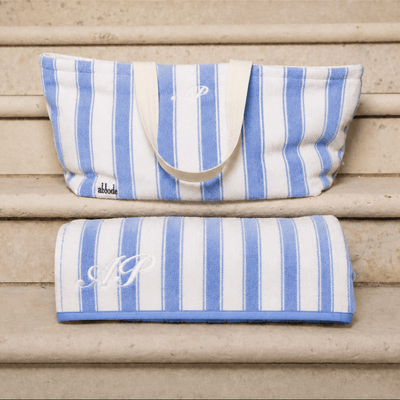 Blue and white striped bag and towel on wooden steps