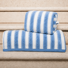 Blue and white striped towels on a wooden surface