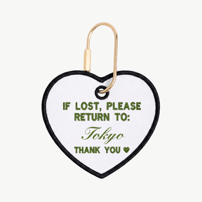 Heart-shaped tag with text 'If lost, please return to: Tokyo' on a white background