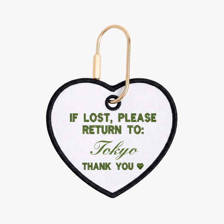 Heart-shaped tag with text 'If lost, please return to: Tokyo' on a white background