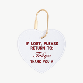 Heart-shaped tag with text 'If lost, please return to: Tokyo' on a white background
