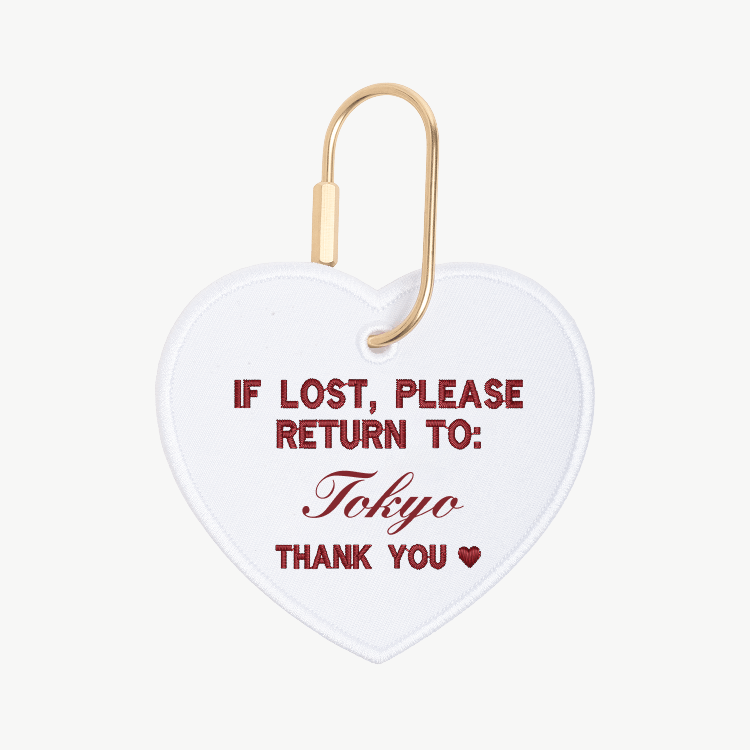 Heart-shaped tag with text 'If lost, please return to: Tokyo' on a white background