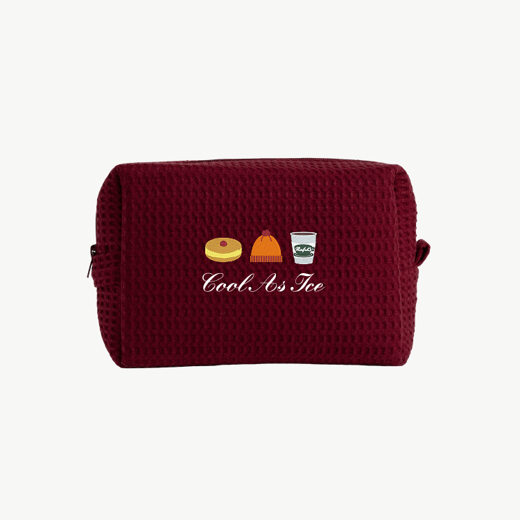 A maroon waffle pouch with embroidered images of a pie, a beanie hat, and a coffee, along with the words Cool As Ice beneath the images.