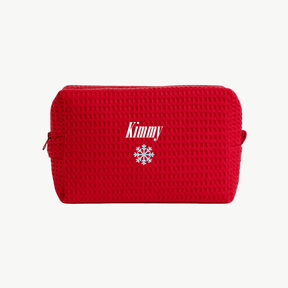 A red, waffle zippered pouch with the name Kimmy and an embroidered snowflake below the name on the front.