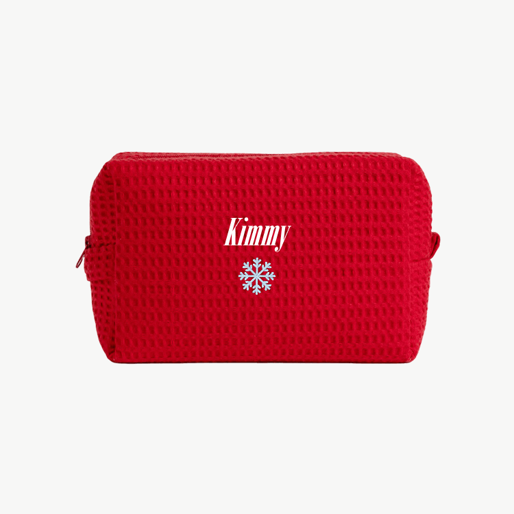 A red, waffle zippered pouch with the name Kimmy and an embroidered snowflake below the name on the front.